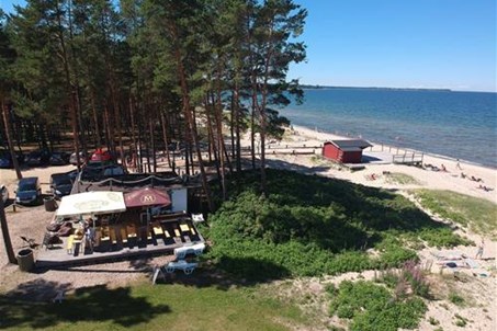 Valkla beach and beach bar, on the left side there is a camping site under the forrest